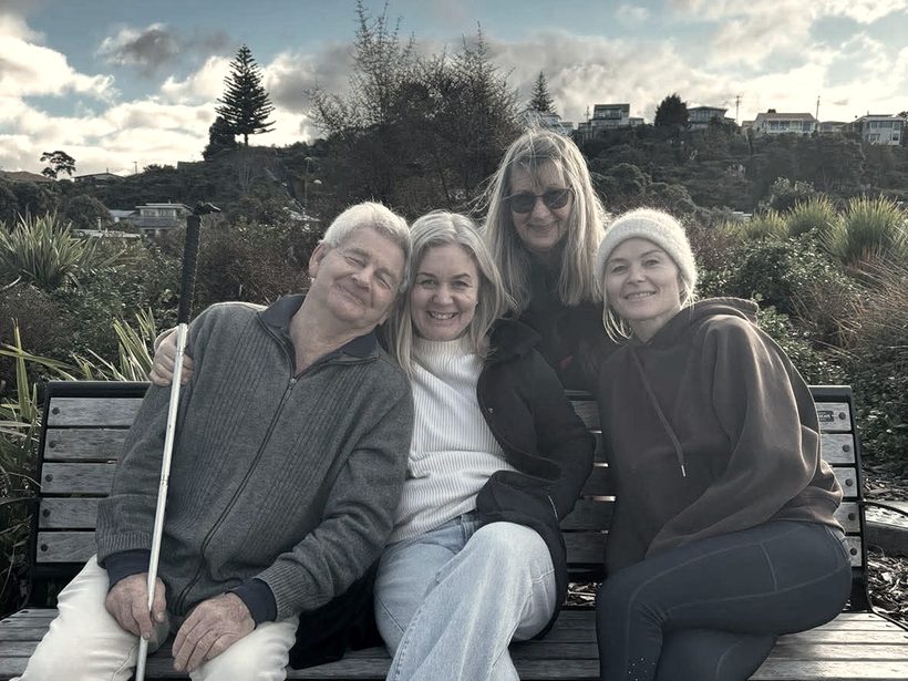 Charlie with her mum, dad and sister by the coast